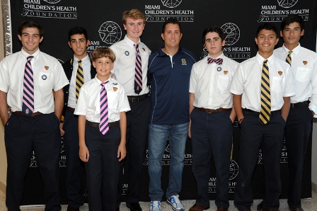 Crew Coach Yunian Cabrera Poses with Members of the Belen Crew Team